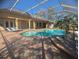 Inviting backyard pool area with a screened-in enclosure and lounge chairs at 42316 E Saffron Ct, Eustis, FL 32736