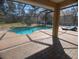 Relaxing poolside patio featuring a screened-in pool, brick pavers, and a lounge chair at 42316 E Saffron Ct, Eustis, FL 32736