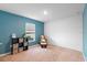 Bright bedroom with blue accent wall, window, and cube storage shelves at 440 Kensington View Dr, Winter Haven, FL 33880