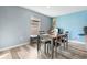 Well lit dining room with wood flooring and seating for six near the kitchen at 440 Kensington View Dr, Winter Haven, FL 33880