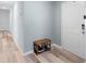 Hallway with light wood floors, a shoe rack, and a white front door at 440 Kensington View Dr, Winter Haven, FL 33880