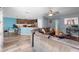 Living room leading into the kitchen, with a large sectional sofa and breakfast bar seating at 440 Kensington View Dr, Winter Haven, FL 33880