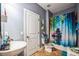 Relaxing bathroom featuring a vessel sink, tiled floors, and a serene shower curtain, creating a spa-like atmosphere at 4654 Coppola Dr, Mount Dora, FL 32757