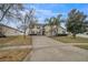 Charming two-story home with a long driveway, lush landscaping, and a welcoming facade at 4654 Coppola Dr, Mount Dora, FL 32757