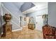 Elegant home foyer with tile flooring, staircase, and stylish decor at 4654 Coppola Dr, Mount Dora, FL 32757