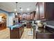 Stylish kitchen with a center island, dark wood cabinets, and stainless steel appliances at 4654 Coppola Dr, Mount Dora, FL 32757