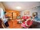 Bright living room featuring hardwood floors, a large window, and elegant red velvet furniture at 4654 Coppola Dr, Mount Dora, FL 32757