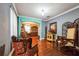 Open-concept living room featuring hardwood floors and vintage, decorative furniture at 4654 Coppola Dr, Mount Dora, FL 32757