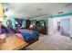 Main bedroom featuring carpet, wooden bed frame, a tv, and views into the rest of the home at 4654 Coppola Dr, Mount Dora, FL 32757