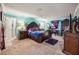 Carpeted main bedroom featuring a wooden bed frame, unique colors, and lots of natural light at 4654 Coppola Dr, Mount Dora, FL 32757