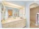 Bright bathroom featuring a large mirror, single sink vanity, and walk-in shower at 480 Ne 45Th Ter, Ocala, FL 34470