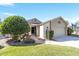 Well-maintained single-story home with manicured lawn and attached two-car garage on a sunny day at 480 Ne 45Th Ter, Ocala, FL 34470