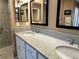 Bathroom featuring double sinks, modern fixtures, and a well-lit vanity at 511 Van Deen Pl, The Villages, FL 34762