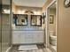 Elegant bathroom featuring double vanity, neutral color palette and shower area at 511 Van Deen Pl, The Villages, FL 34762