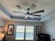 Bedroom features modern ceiling fan, tray ceiling, plantation shutters, and recessed lighting at 511 Van Deen Pl, The Villages, FL 34762