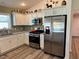 Bright kitchen featuring stainless steel appliances and tile backsplash at 511 Van Deen Pl, The Villages, FL 34762