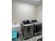 Laundry room with stainless steel washer and dryer plus a utility sink at 511 Van Deen Pl, The Villages, FL 34762