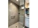 Modern tiled shower with glass door and grab bar for safety and style at 511 Van Deen Pl, The Villages, FL 34762