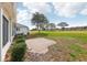 Exterior side view of home features patio and a large green lawn with mature trees at 5332 Nw 20Th Pl, Ocala, FL 34482