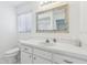 Bright bathroom features a vanity, toilet, and plenty of light from the window at 5332 Nw 20Th Pl, Ocala, FL 34482