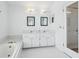 Bathroom vanity area and soaking tub featuring tiled floors at 5332 Nw 20Th Pl, Ocala, FL 34482