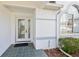 Close-up of the front door featuring a glass panel door and decorative window feature at 5332 Nw 20Th Pl, Ocala, FL 34482