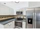 Modern kitchen with stainless steel appliances and white cabinetry provides an efficient cooking space at 5332 Nw 20Th Pl, Ocala, FL 34482