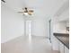 Living area featuring tile flooring, a ceiling fan, and a view into the kitchen at 5332 Nw 20Th Pl, Ocala, FL 34482