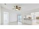 Living room area with tile floors, modern ceiling fan, and entrance into the kitchen at 5332 Nw 20Th Pl, Ocala, FL 34482