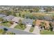 Aerial view of the home and community with golf course and ponds at 565 Brighton Dr, The Villages, FL 32162