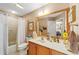 Bathroom featuring a shower and vanity with wood cabinets at 565 Brighton Dr, The Villages, FL 32162