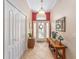 Grand entryway with a decorative wreath on the front door, tile floor, and a console table at 565 Brighton Dr, The Villages, FL 32162