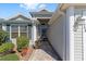 Inviting entryway with a brick walkway and lush landscaping leading to the front door of this beautiful home at 565 Brighton Dr, The Villages, FL 32162