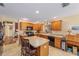 Spacious kitchen featuring tile floors, an island, and wooden cabinets at 565 Brighton Dr, The Villages, FL 32162