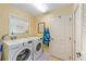 Functional laundry room with modern washer and dryer units at 565 Brighton Dr, The Villages, FL 32162