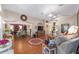 Bright and airy living room featuring hardwood floors, an open layout, and seamless flow into other living spaces at 565 Brighton Dr, The Villages, FL 32162