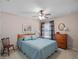 Well-lit bedroom features neutral paint, a ceiling fan, and a comfortable layout at 5718 Illumination Ln, Leesburg, FL 34748