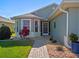 Charming single-story home featuring a brick walkway, meticulous landscaping, and front-facing bay windows at 5718 Illumination Ln, Leesburg, FL 34748