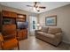 Comfortable living room with a large sofa and a built-in bookcase at 5718 Illumination Ln, Leesburg, FL 34748