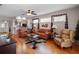 Comfortable living room featuring hardwood floors, lots of natural light, and a seamless connection to the kitchen at 5718 Illumination Ln, Leesburg, FL 34748