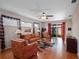 Spacious living room featuring hardwood floors, lots of natural light, and a seamless connection to the outside lanai at 5718 Illumination Ln, Leesburg, FL 34748