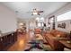 Inviting living room featuring hardwood floors, plenty of natural light, and an open flow to the dining area at 5718 Illumination Ln, Leesburg, FL 34748