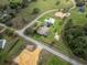 Aerial view of home, featuring a screened-in pool and spacious lawn in a serene, pastoral neighborhood at 6206 Ocilla Loop, Clermont, FL 34714