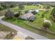 Aerial view of a beautiful countryside home, showcasing a screened-in pool, well-maintained lawn, and peaceful setting at 6206 Ocilla Loop, Clermont, FL 34714