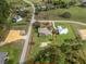 Aerial view of property with red outline, showing a screened pool, and surrounding green landscape at 6206 Ocilla Loop, Clermont, FL 34714