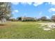 Expansive backyard with lush lawn, mature trees, and a charming screened pool at 6206 Ocilla Loop, Clermont, FL 34714