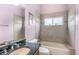 Cozy bathroom with tiled shower, granite vanity, tub, and natural light from the window at 6206 Ocilla Loop, Clermont, FL 34714