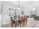 Bright dining room with plantation shutters and a large dark wood table at 6206 Ocilla Loop, Clermont, FL 34714