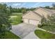 Overhead view of a three-car garage and expansive driveway at 6206 Ocilla Loop, Clermont, FL 34714