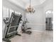 Spacious exercise room with a treadmill, elliptical, and view of the kitchen at 6206 Ocilla Loop, Clermont, FL 34714